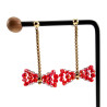 Lange Oorbellen met Rode Kristallen Strik en Verguld RVS - Lengte 53mm